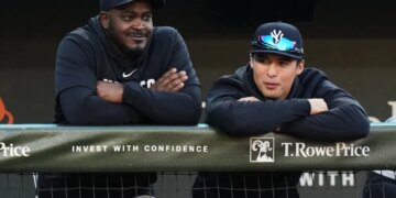 Anthony Volpe (r.) watches from the Yankees dugout during a game against the Orioles on May 12, 2026.