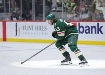 Quinn Hughes (43) of the Minnesota Wild skates on the ice during a game.