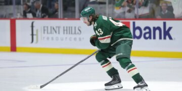 Quinn Hughes (43) of the Minnesota Wild skates on the ice during a game.
