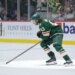 Quinn Hughes (43) of the Minnesota Wild skates on the ice during a game.