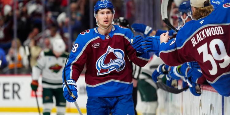 Colorado Avalanche player Martin Necas (88) celebrating a goal with his teammates during a game.