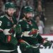 Minnesota Wild players Quinn Hughes and Ryan Hartman on the ice during an NHL playoff game.