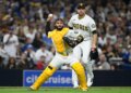 San Diego Padres catcher Austin Nola throws to a base as pitcher Joe Musgrove watches.