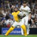San Diego Padres catcher Austin Nola throws to a base as pitcher Joe Musgrove watches.