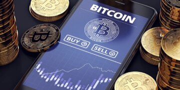 Illustration of a smartphone displaying a Bitcoin trading app with buy/sell options and a price chart, surrounded by stacks of golden Bitcoin coins.