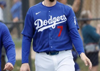 Baseball player Jason Heyward walks on the field wearing a Los Angeles Dodgers uniform with the number 7.