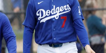 Baseball player Jason Heyward walks on the field wearing a Los Angeles Dodgers uniform with the number 7.