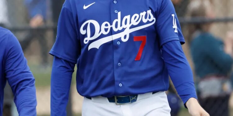 Baseball player Jason Heyward walks on the field wearing a Los Angeles Dodgers uniform with the number 7.