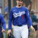 Baseball player Jason Heyward walks on the field wearing a Los Angeles Dodgers uniform with the number 7.