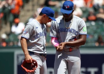 Toronto Blue Jays players Jesus Sanchez and Andres Gimenez speak on the field.