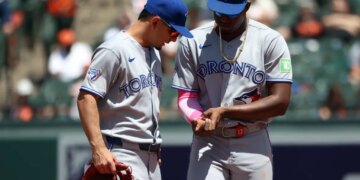 Toronto Blue Jays players Jesus Sanchez and Andres Gimenez speak on the field.