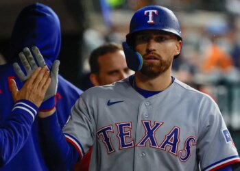 Texas Rangers right fielder Brandon Nimmo (24) receives congratulations from teammates after scoring 3i against the Detroit Tigers at Comerica Park.