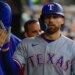 Texas Rangers right fielder Brandon Nimmo (24) receives congratulations from teammates after scoring 3i against the Detroit Tigers at Comerica Park.