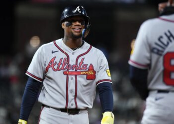 Atlanta Braves outfielder Ronald Acuna Jr. smiling in his uniform.