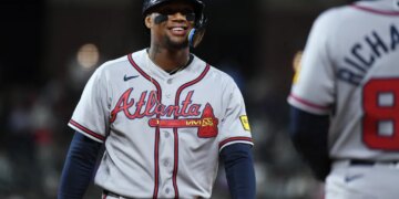 Atlanta Braves outfielder Ronald Acuna Jr. smiling in his uniform.