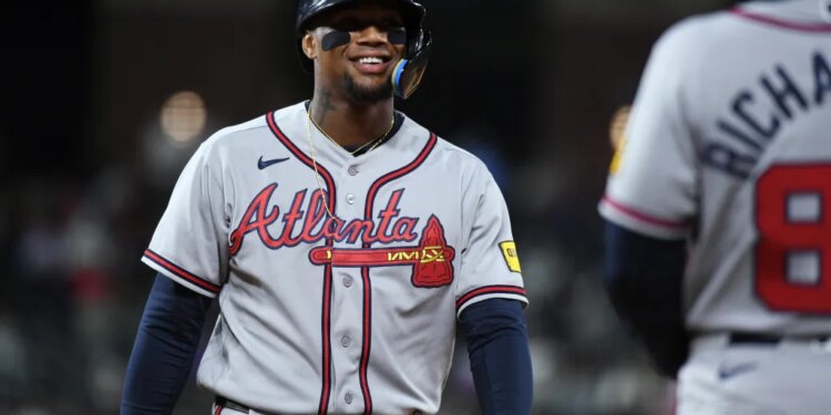 Atlanta Braves outfielder Ronald Acuna Jr. smiling in his uniform.