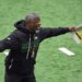 Jets head coach Aaron Glenn shouting and holding papers during practice.