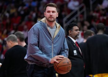 Luka Doncic holds a basketball during a timeout.