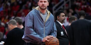 Luka Doncic holds a basketball during a timeout.