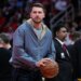 Luka Doncic holds a basketball during a timeout.