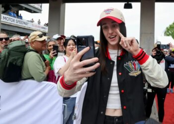 Indiana Fever guard Caitlin Clark takes a selfie with fans at the 110th Running of the Indianapolis 500.
