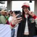 Indiana Fever guard Caitlin Clark takes a selfie with fans at the 110th Running of the Indianapolis 500.