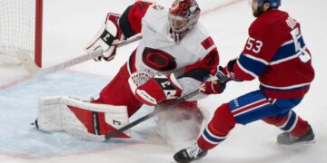 Carolina Hurricanes goalie Frederik Andersen makes a save against Montreal Canadiens' Noah Dobson during an NHL game.