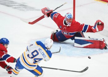 Buffalo Sabres' Konsta Helenius (94) shoots and scores against Montreal Canadiens goaltender Jakub Dobes (75) as Canadiens' Arber Xhekaj, left, defends during the second period of Game 6 in a second-round NHL hockey Stanley Cup playoff series in Montreal, Saturday, May 16, 2026. (Graham Hughes/The Canadian Press via AP)