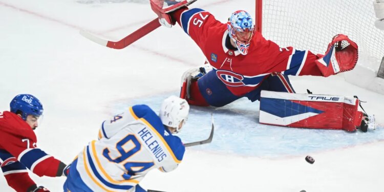 Buffalo Sabres' Konsta Helenius (94) shoots and scores against Montreal Canadiens goaltender Jakub Dobes (75) as Canadiens' Arber Xhekaj, left, defends during the second period of Game 6 in a second-round NHL hockey Stanley Cup playoff series in Montreal, Saturday, May 16, 2026. (Graham Hughes/The Canadian Press via AP)