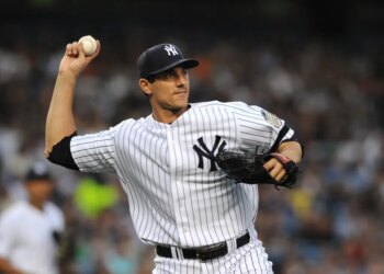Yankees pitcher Carl Pavano attempts a pick off.
