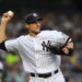 Yankees pitcher Carl Pavano attempts a pick off.