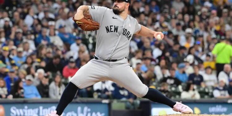 New York Yankees pitcher Carlos Rodon pitches against the Milwaukee Brewers.