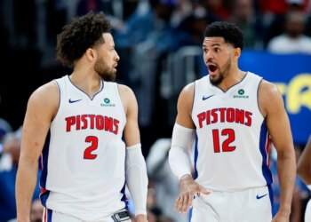 Cade Cunningham and Tobias Harris in Pistons jerseys on the court.