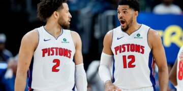 Cade Cunningham and Tobias Harris in Pistons jerseys on the court.