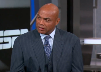 Charles Barkley in a pinstripe suit and tie, looking slightly to the right.