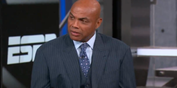 Charles Barkley in a pinstripe suit and tie, looking slightly to the right.