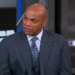 Charles Barkley in a pinstripe suit and tie, looking slightly to the right.