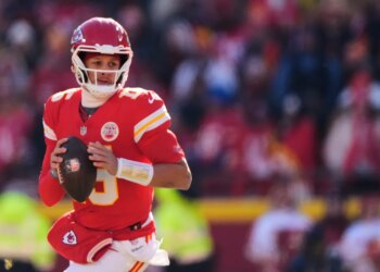 Kansas City Chiefs quarterback Patrick Mahomes looks to pass during the first half of an NFL football game against the Los Angeles Chargers, Dec. 14, 2025, in Kansas City, Mo.