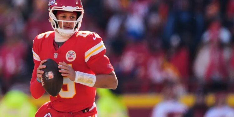 Kansas City Chiefs quarterback Patrick Mahomes looks to pass during the first half of an NFL football game against the Los Angeles Chargers, Dec. 14, 2025, in Kansas City, Mo.