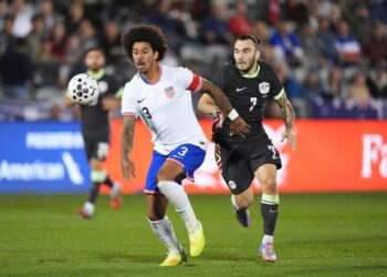 United States defender Chris Richards pursuing the ball with Australia forward Nicholas D'Agostino.