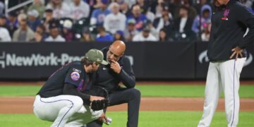 New York Mets pitcher Clay Holmes (35) has a trainer look at him during the fourth inning when the New York Mets played the New York Yankees Friday, May 15, 2026 at Citi Field in Queens, NY.