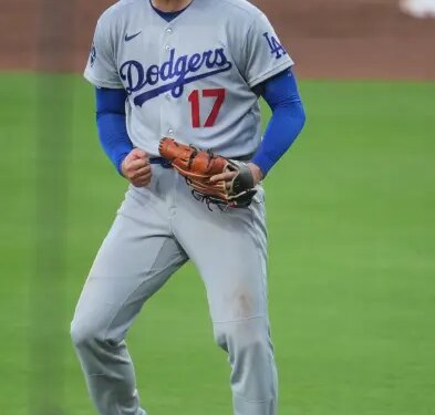 Shohei Ohtani in a Dodgers uniform clenching his fist and yelling.