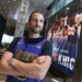 Evan Perlmutter, a former Knicks fan now a Lakers fan, stands with his arms crossed in a Lakers jersey at Madison Square Garden.