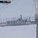 A construction worker exercising on top of a Webcor sign at a Cal Baptist vs. UCSB game.
