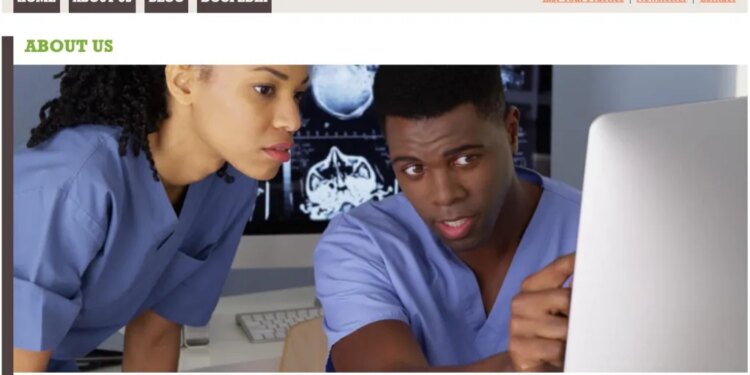 Homepage for FindABlackDoctor.com featuring two doctors looking at a computer monitor displaying brain scans.