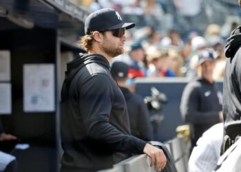 New York Yankees player Gerrit Cole in the dugout during a baseball game.