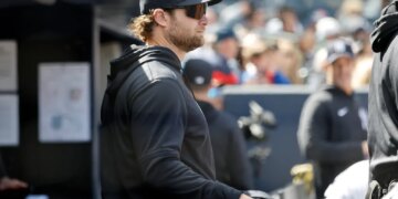 New York Yankees player Gerrit Cole in the dugout during a baseball game.