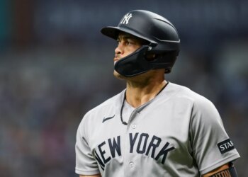 Giancarlo Stanton in a New York Yankees uniform and batting helmet.