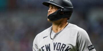 Giancarlo Stanton in a New York Yankees uniform and batting helmet.