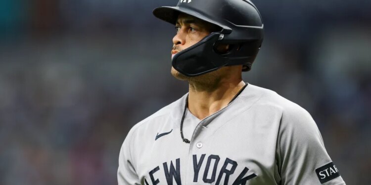 Giancarlo Stanton in a New York Yankees uniform and batting helmet.